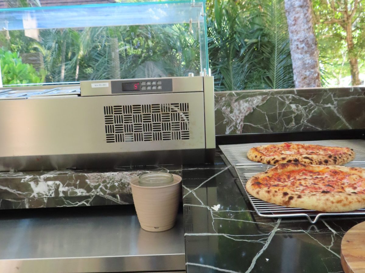 Pizzas on the marble counter with refrigerated display at Kannel Pizzeria, Four Seasons Mahe